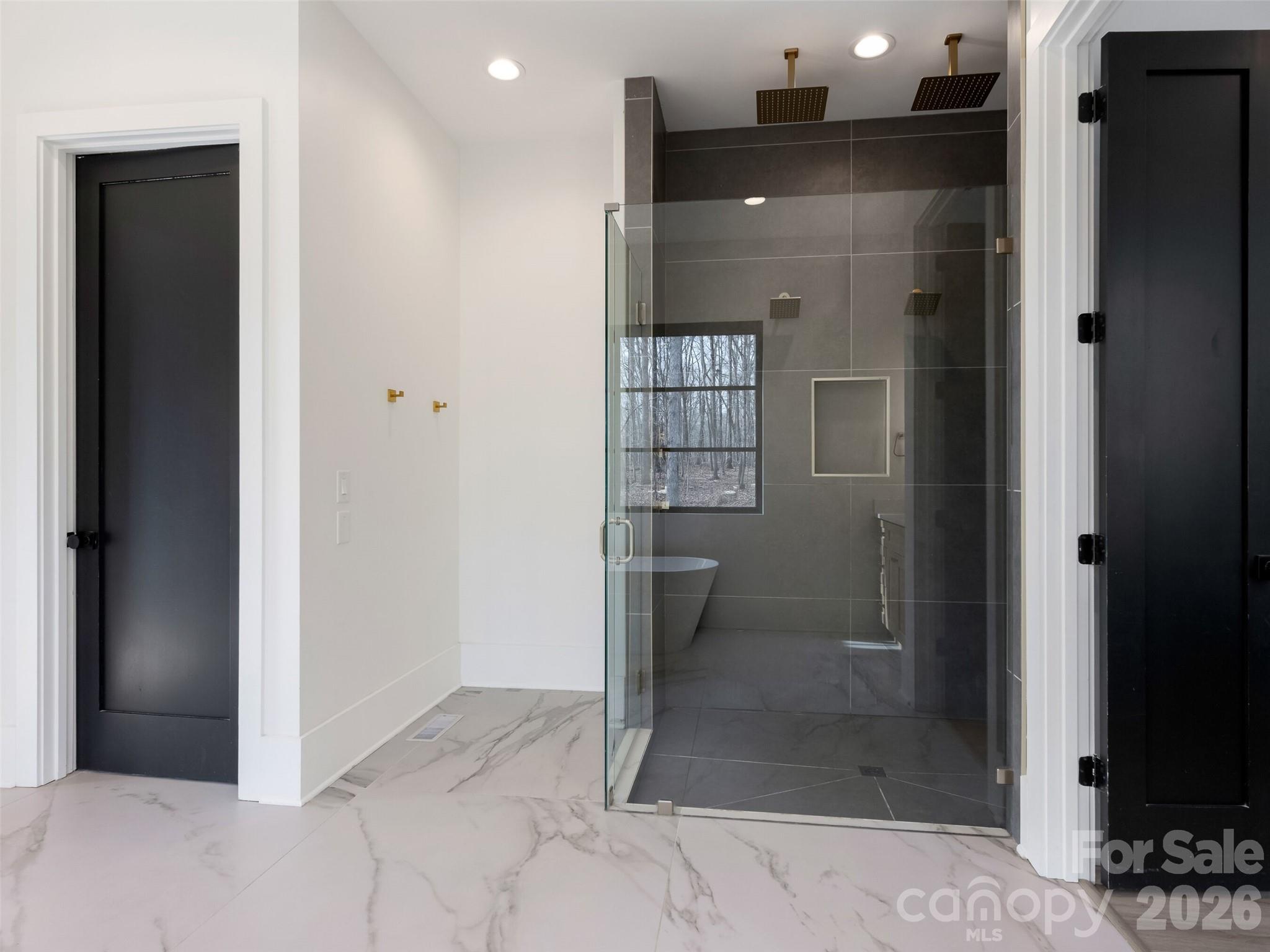 6017 Oxfordshire Road Waxhaw, NC 28173 - Photo 23 of 48 a bathroom with a glass shower door