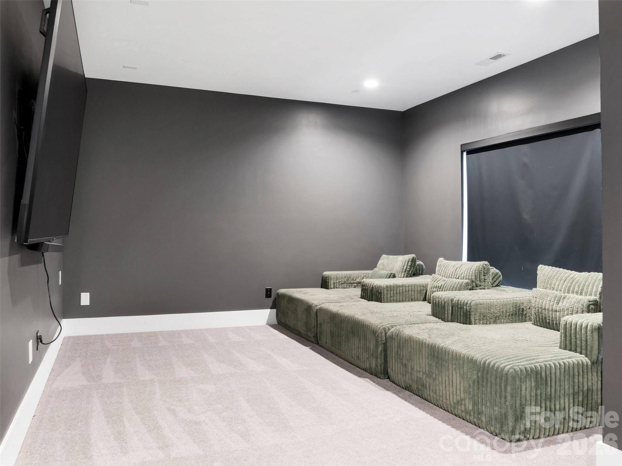 6017 Oxfordshire Road Waxhaw, NC 28173 - Photo 33 of 48 a living room with furniture and a flat screen tv