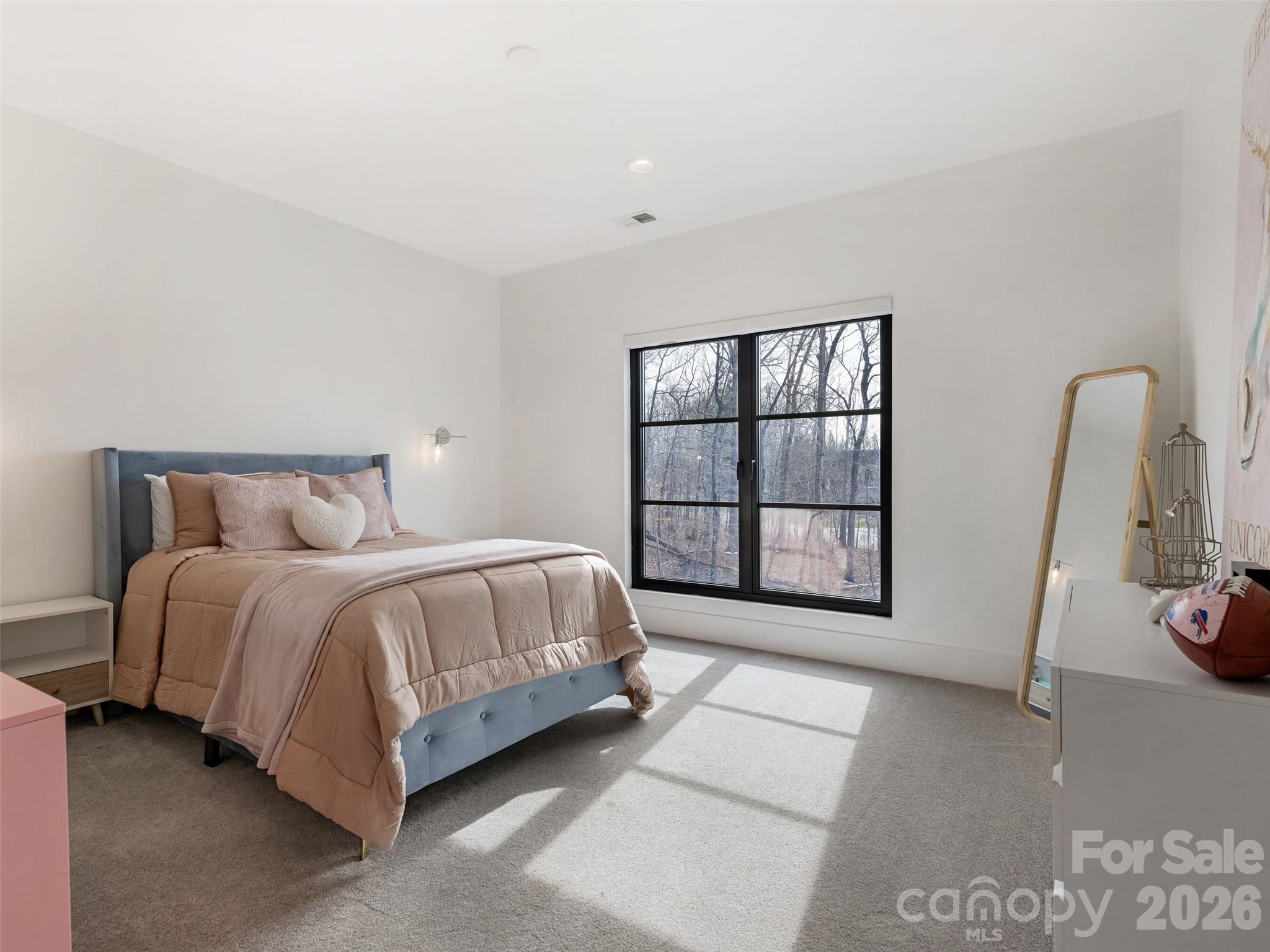 6017 Oxfordshire Road Waxhaw, NC 28173 - Photo 37 of 48 a spacious bedroom with a bed and a window