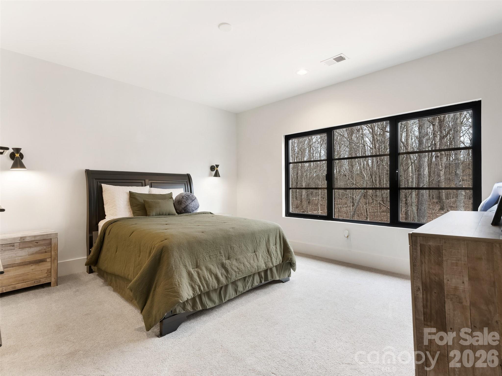 6017 Oxfordshire Road Waxhaw, NC 28173 - Photo 39 of 48 a spacious bedroom with a large bed and a large window