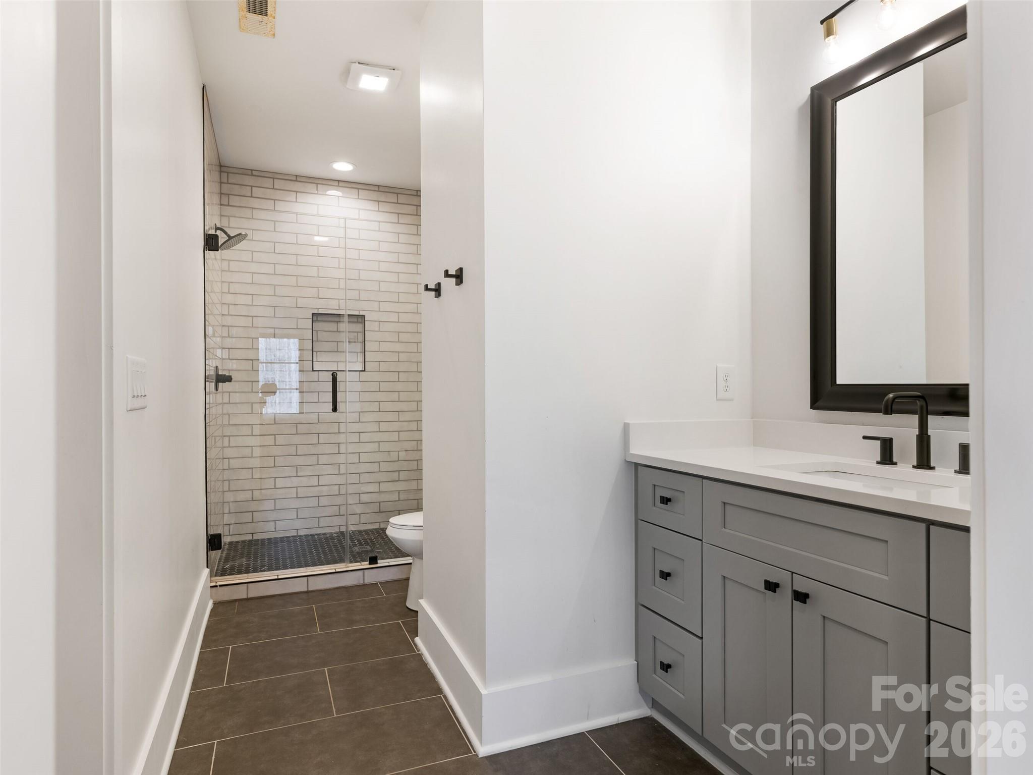 6017 Oxfordshire Road Waxhaw, NC 28173 - Photo 40 of 48 a bathroom with a sink and a mirror