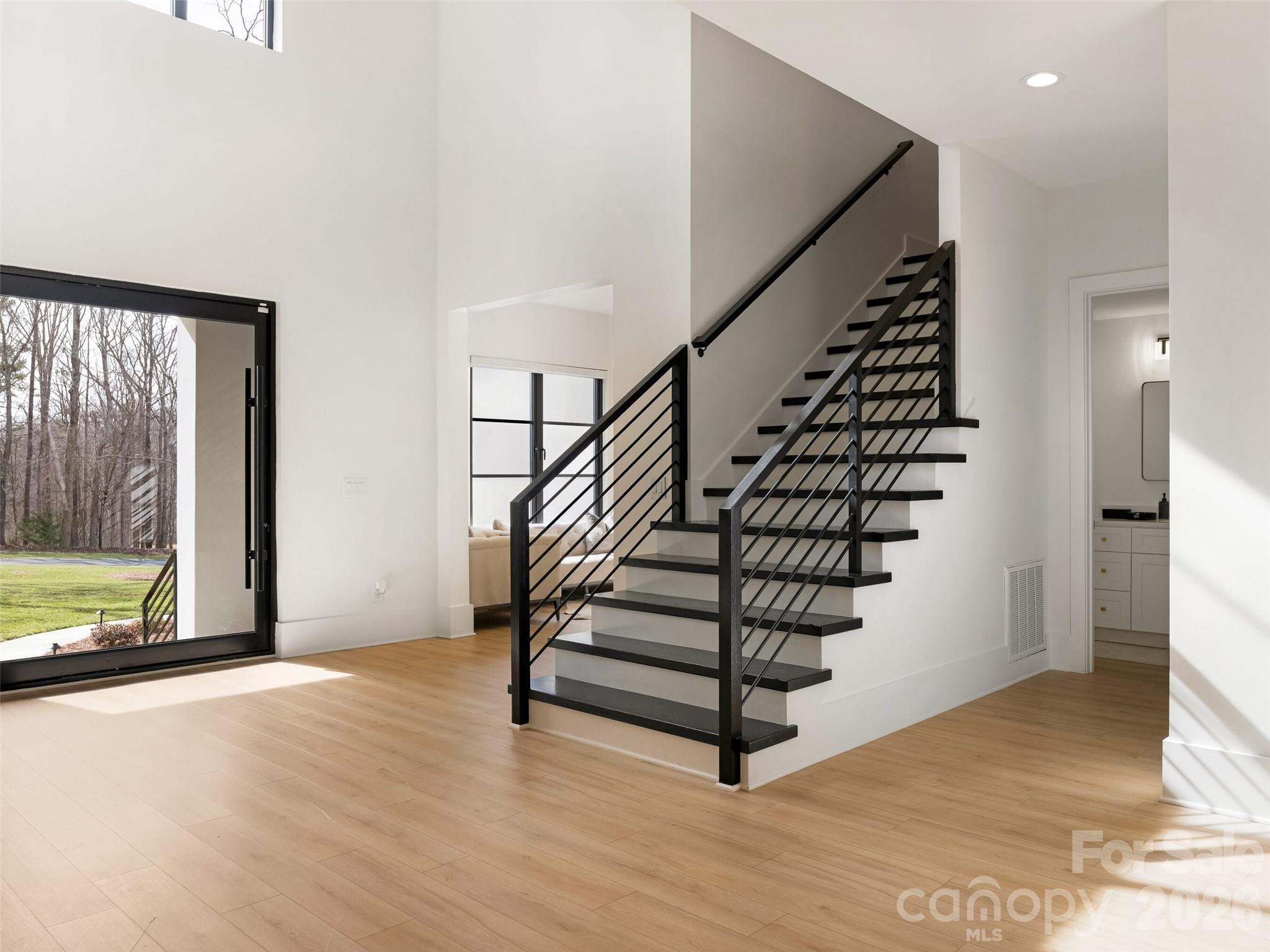 6017 Oxfordshire Road Waxhaw, NC 28173 - Photo 4 of 48 a view of an entryway with wooden floor and windows