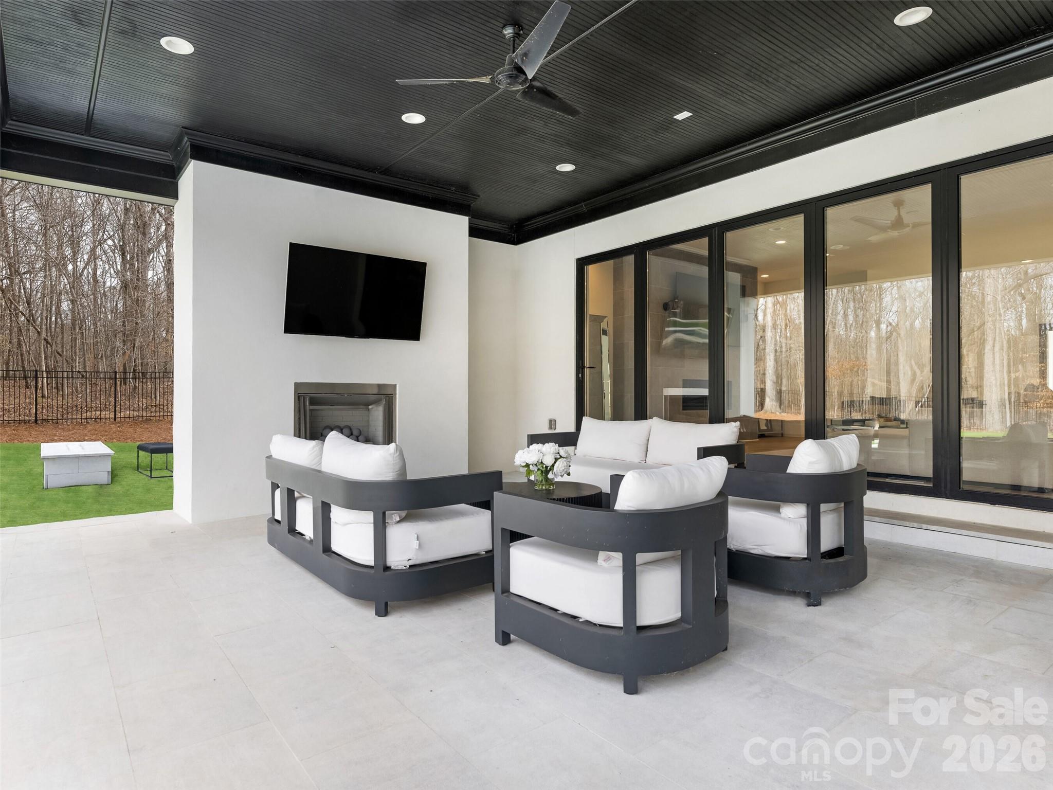 6017 Oxfordshire Road Waxhaw, NC 28173 - Photo 42 of 48 a living room with fireplace furniture and a flat screen tv