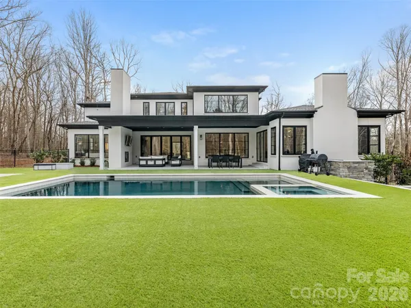 a view of house with a swimming pool