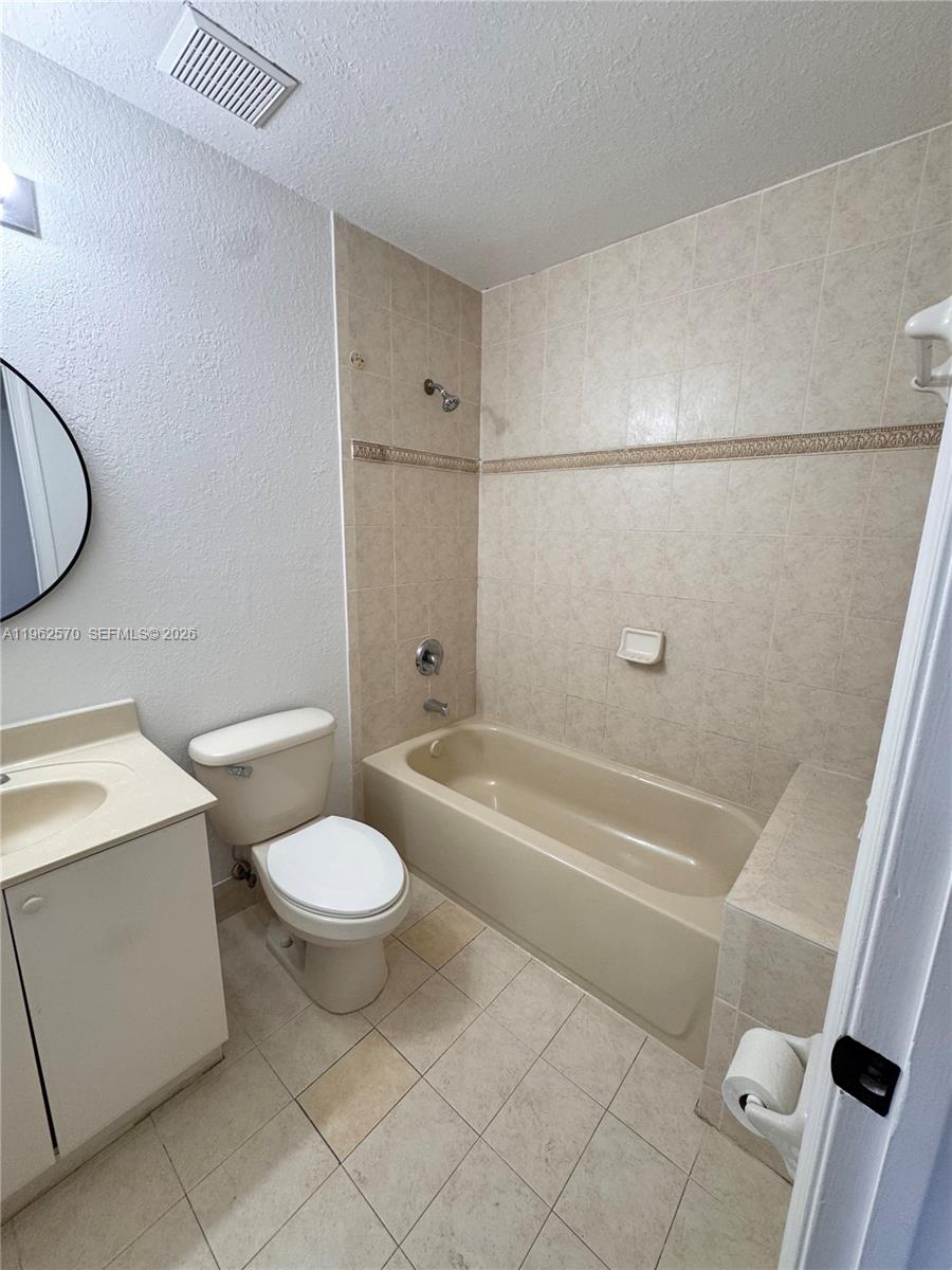 2732 Southeast 15th Place, Unit 142 Homestead, FL 33035 - Photo 12 of 20 a bathroom with a sink a toilet and a bathtub