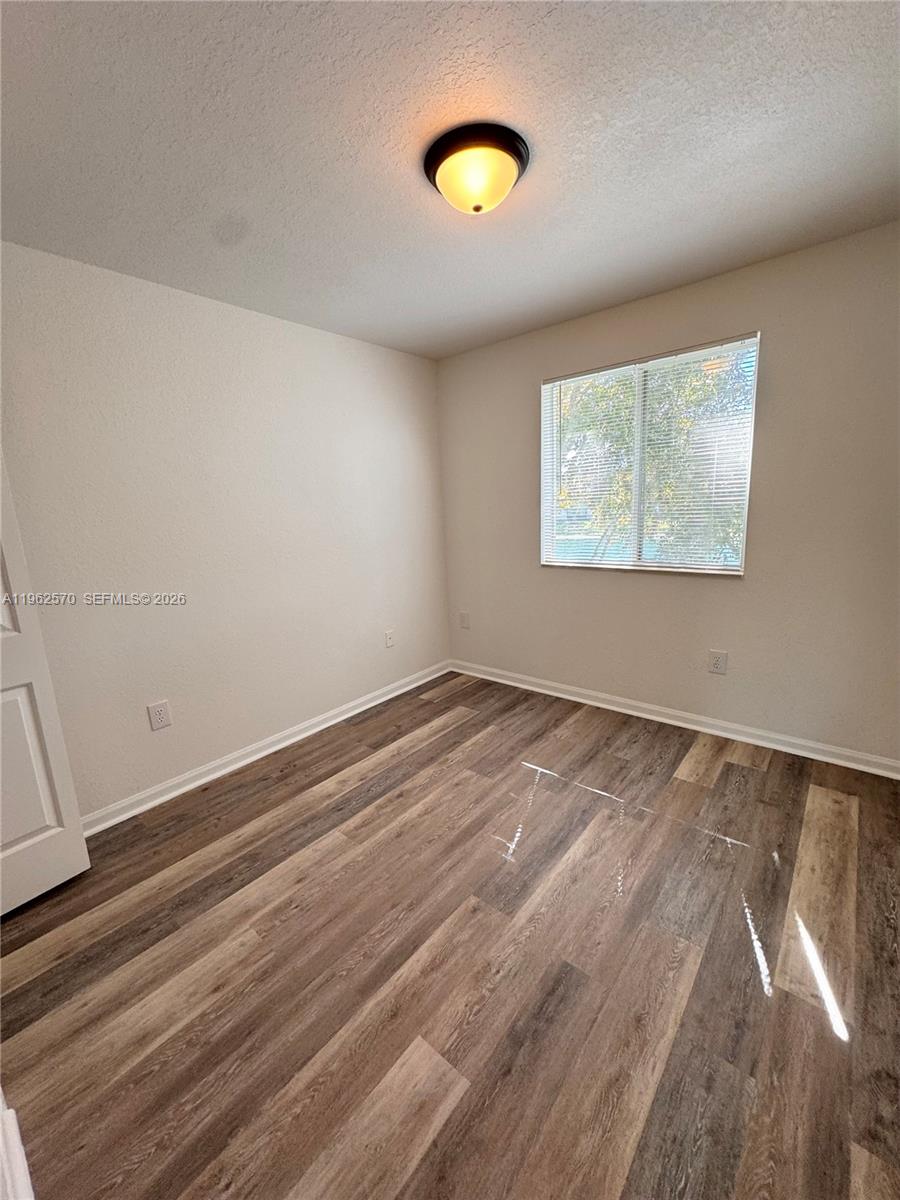 2732 Southeast 15th Place, Unit 142 Homestead, FL 33035 - Photo 13 of 20 wooden floor in an empty room