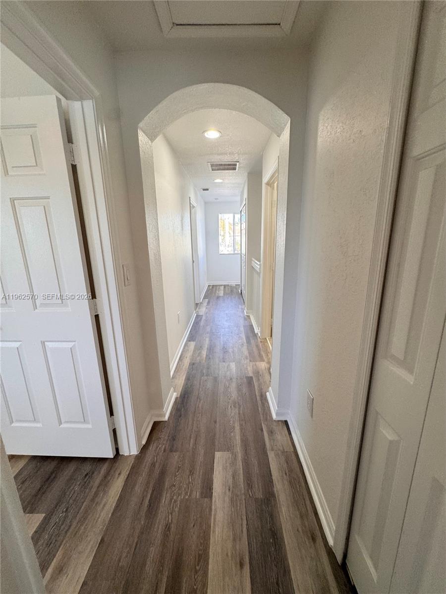 2732 Southeast 15th Place, Unit 142 Homestead, FL 33035 - Photo 16 of 20 a view of a hallway with wooden floor and staircase