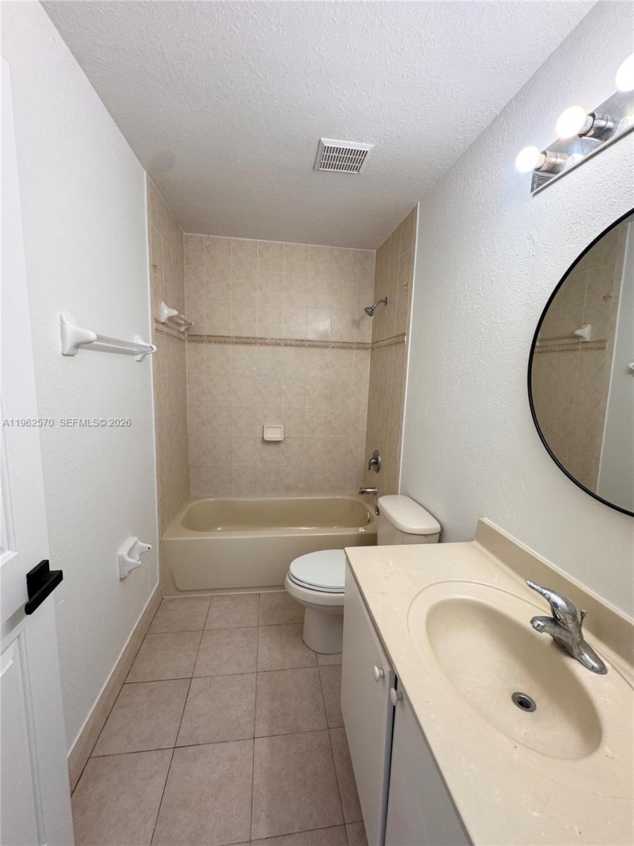 2732 Southeast 15th Place, Unit 142 Homestead, FL 33035 - Photo 18 of 20 a bathroom with a sink a toilet and shower