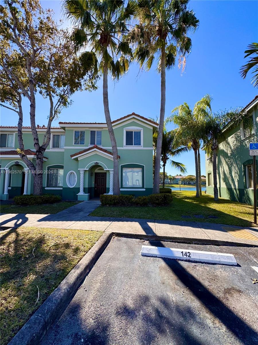 2732 Southeast 15th Place, Unit 142 Homestead, FL 33035 - Photo 2 of 20 a front view of a house with a yard