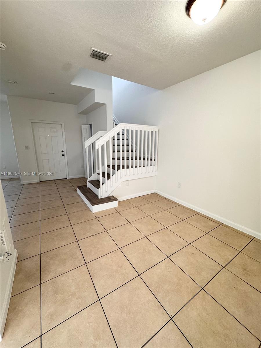2732 Southeast 15th Place, Unit 142 Homestead, FL 33035 - Photo 5 of 20 a view of an empty room and wooden floor
