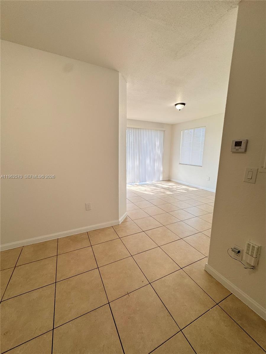 2732 Southeast 15th Place, Unit 142 Homestead, FL 33035 - Photo 7 of 20 a view of an empty room and window