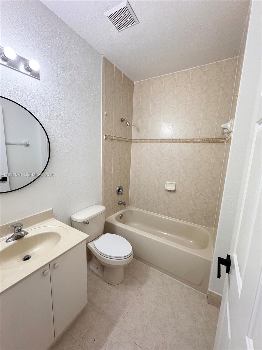 2732 Southeast 15th Place, Unit 142 Homestead, FL 33035 - Photo 8 of 20 a bathroom with a granite countertop sink a toilet and bathtub