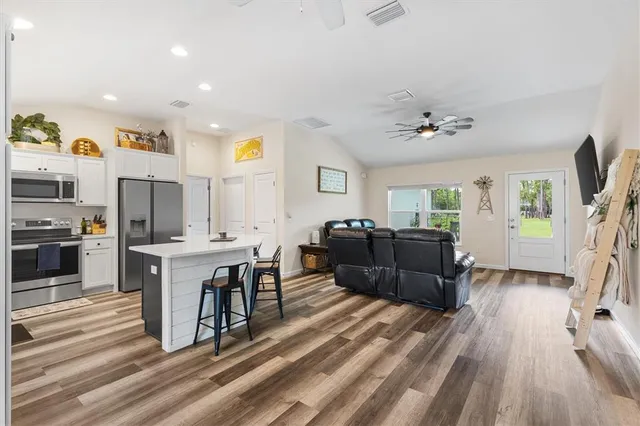 a living room with furniture and a wooden floor