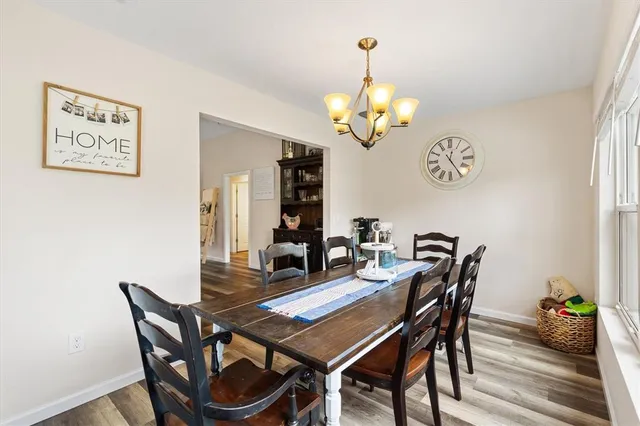 a view of a dining room with furniture and chandelier