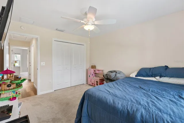 a bedroom with two beds and a chandelier