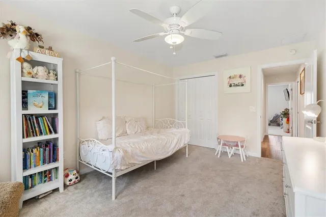 a bedroom with furniture and a book shelf
