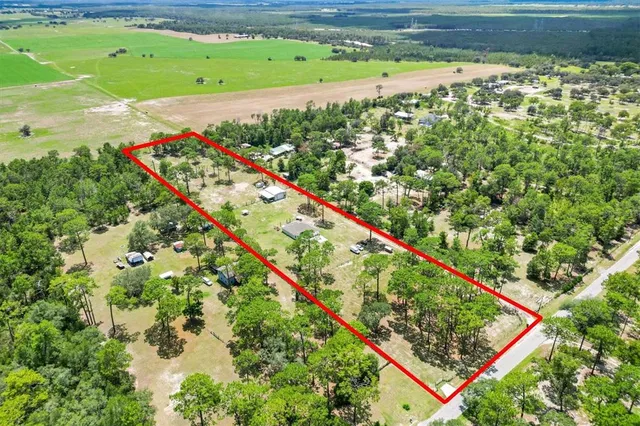 a view of a green field with an outdoor space