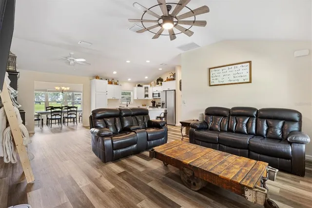 a living room with furniture with kitchen view