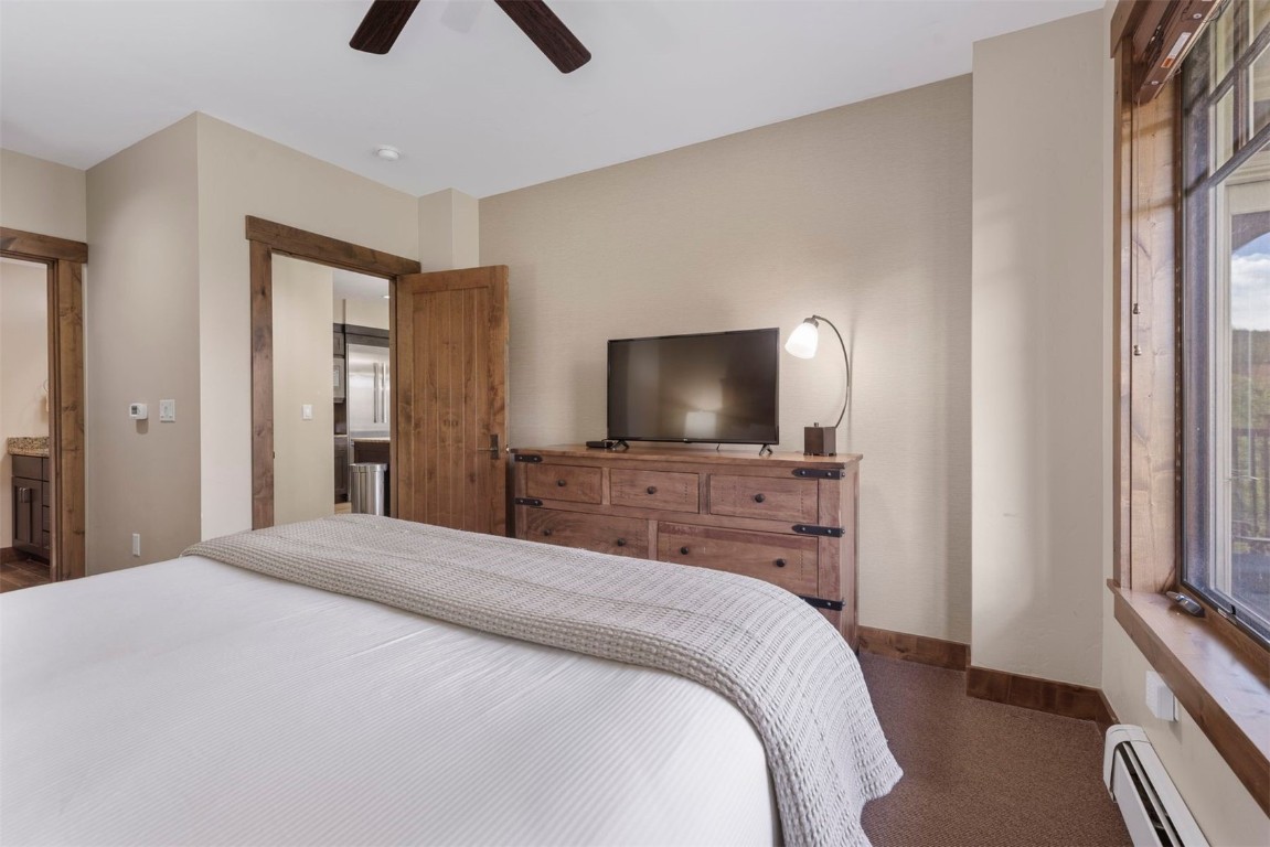610 Columbine Road, Unit 6307 Breckenridge, CO 80424 - Photo 19 of 36 a bedroom with a bed and a flat screen tv