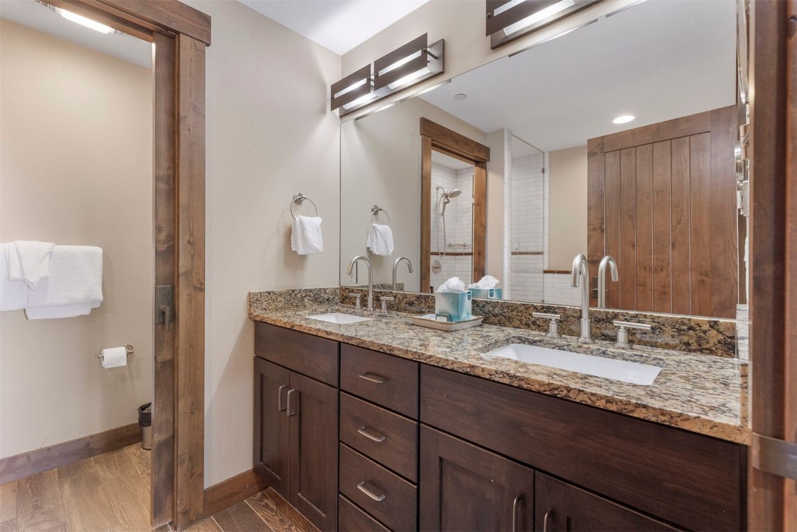 610 Columbine Road, Unit 6307 Breckenridge, CO 80424 - Photo 20 of 36 a bathroom with a granite countertop sink and a mirror