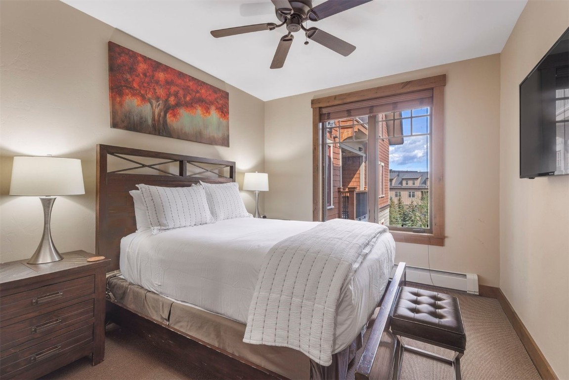 610 Columbine Road, Unit 6307 Breckenridge, CO 80424 - Photo 22 of 36 a bedroom with a bed and a painting on the wall