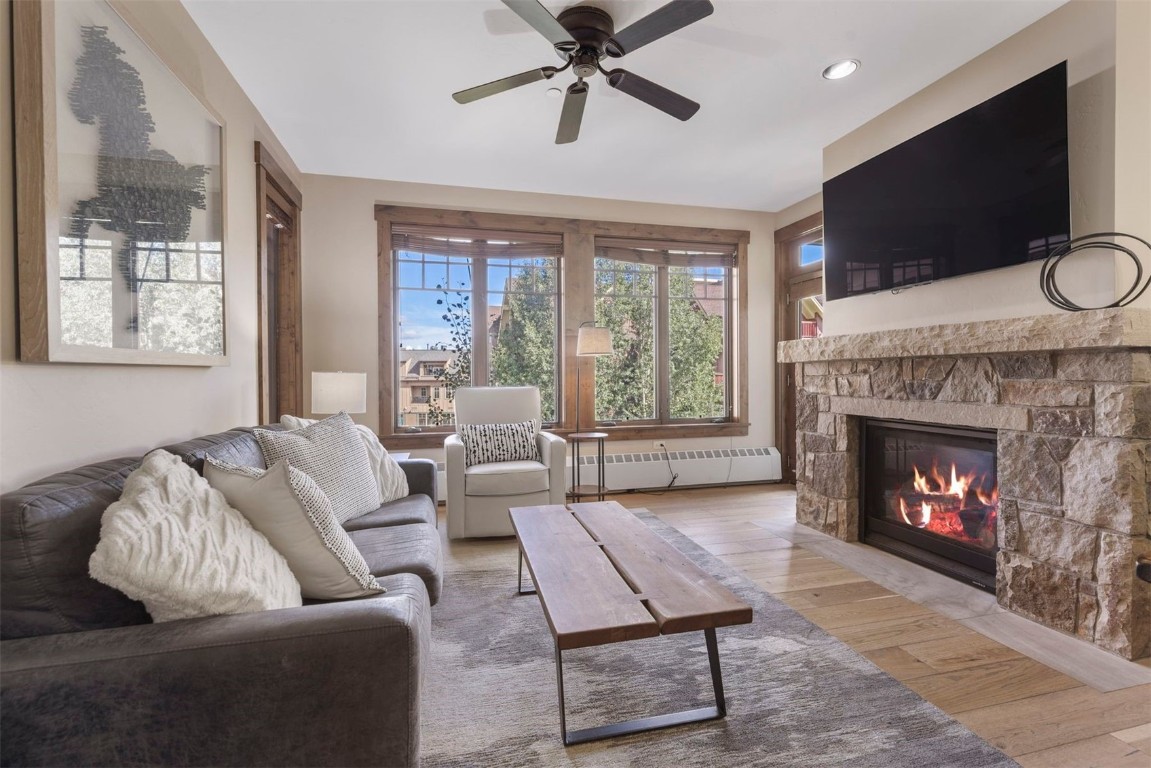 610 Columbine Road, Unit 6307 Breckenridge, CO 80424 - Photo 4 of 36 a living room with furniture a flat screen tv and a fireplace