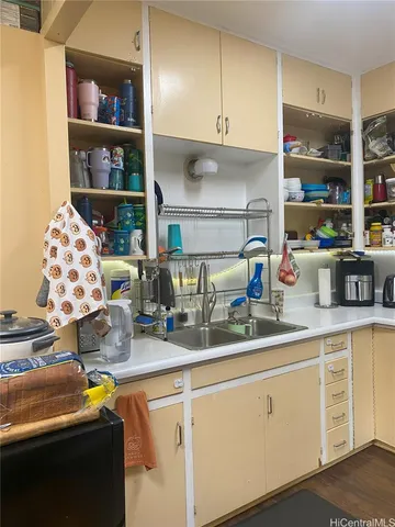 a kitchen with stainless steel appliances granite countertop a sink a stove and cabinets