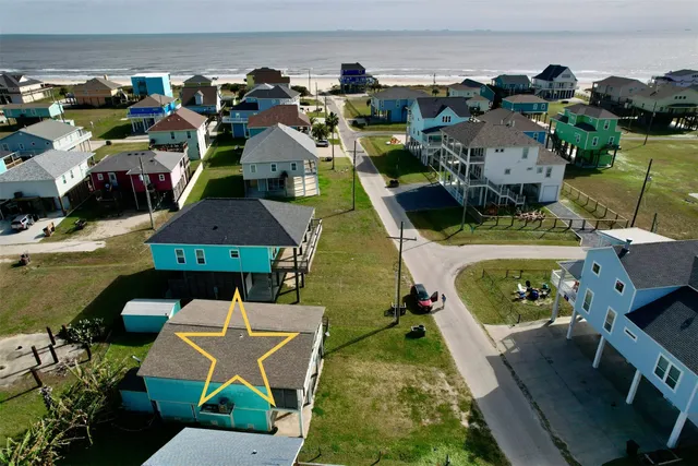 an aerial view of a house with a swimming pool outdoor seating and yard