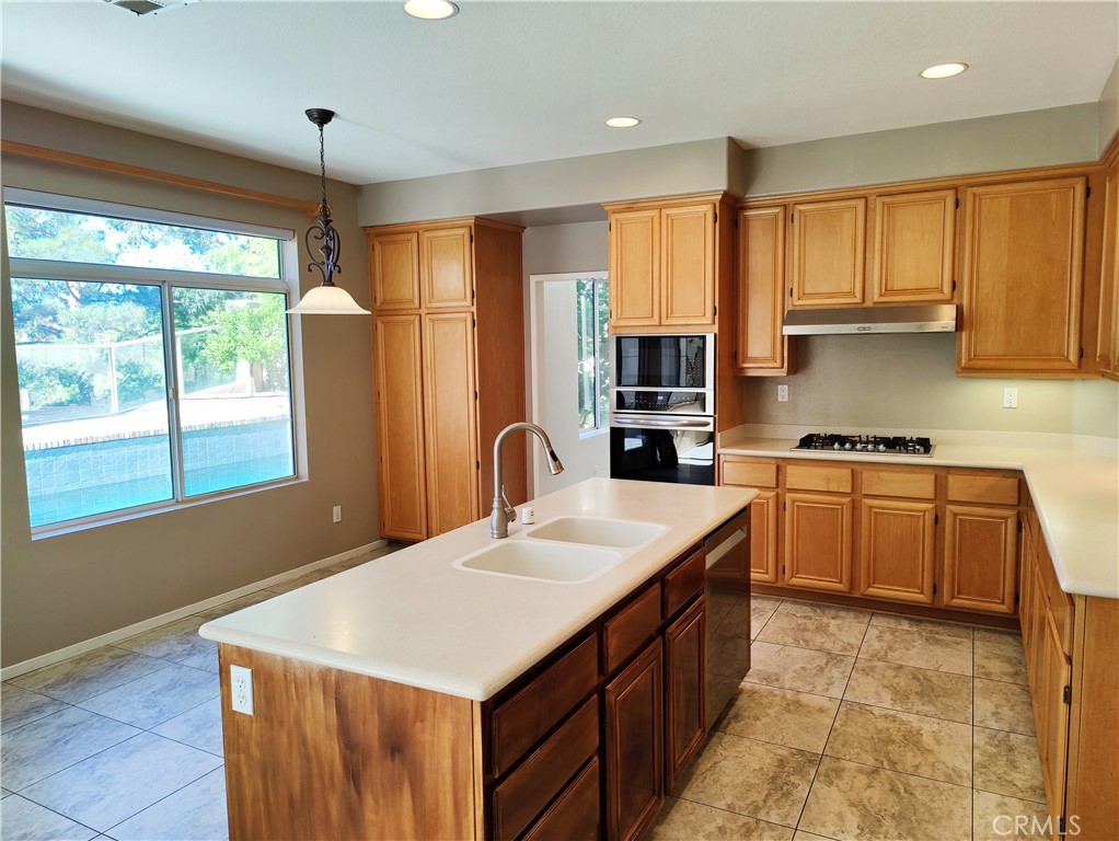 8 Vía Anadeja Rancho Santa Margarita, CA 92688 - Photo 5 of 22 a kitchen with stainless steel appliances granite countertop a sink a stove and a refrigerator