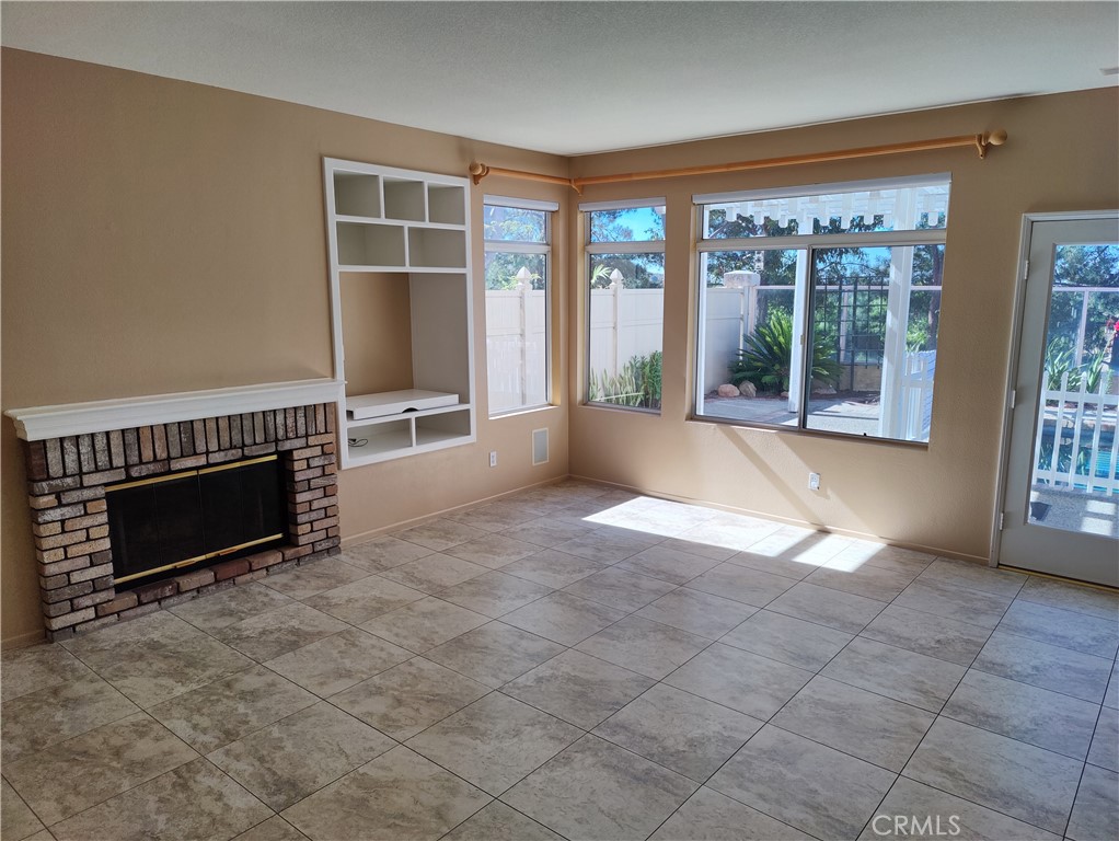 8 Vía Anadeja Rancho Santa Margarita, CA 92688 - Photo 6 of 22 an empty room with furniture and a fireplace
