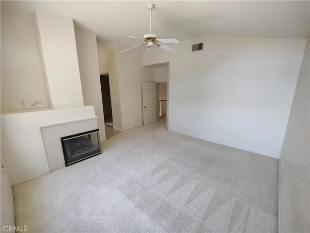 a view of an empty room with a fireplace