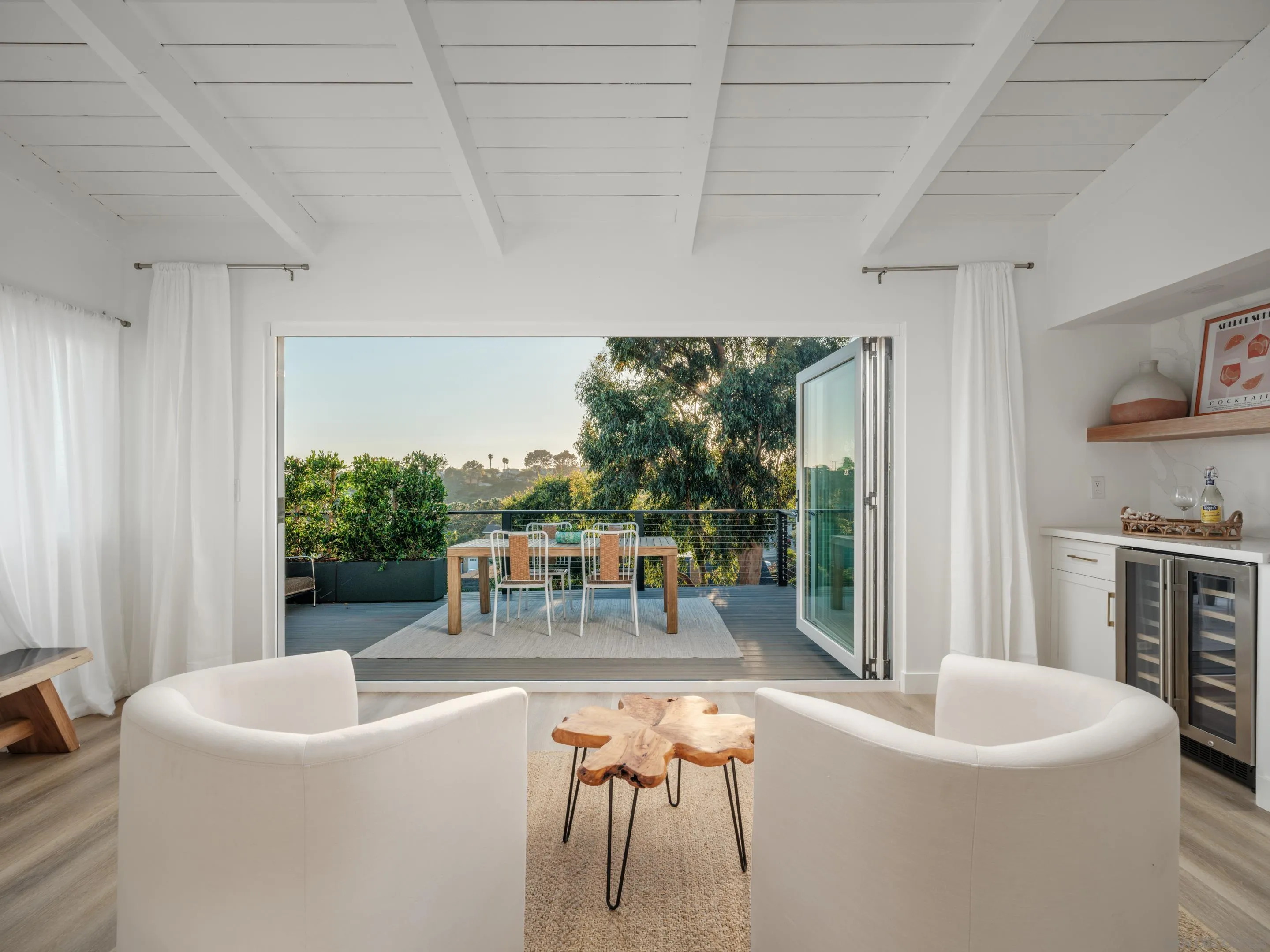 a living room with patio furniture and a fireplace