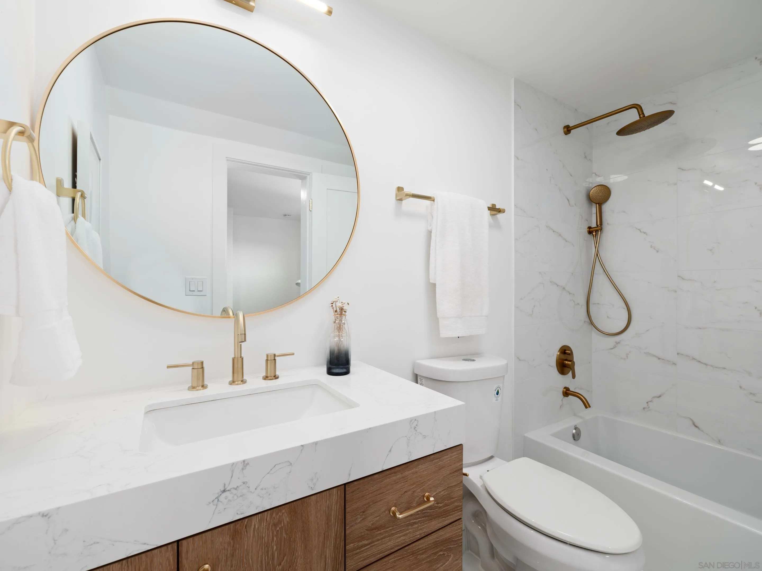 1868 Pariva Drive Cardiff, CA 92007 - Photo 19 of 30 a bathroom with a sink a toilet and a mirror
