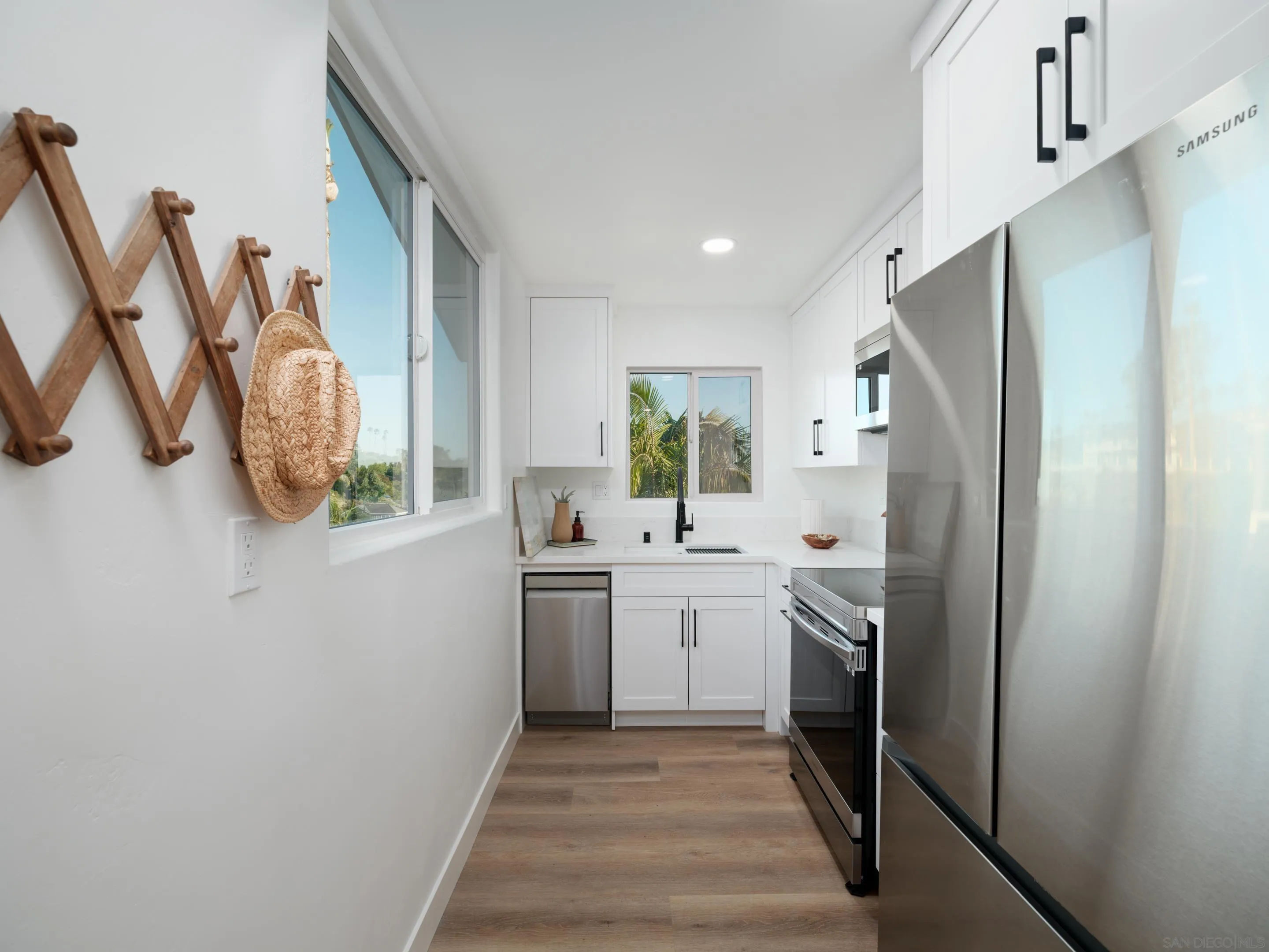 1868 Pariva Drive Cardiff, CA 92007 - Photo 26 of 30 a kitchen with stainless steel appliances granite countertop a refrigerator and a sink