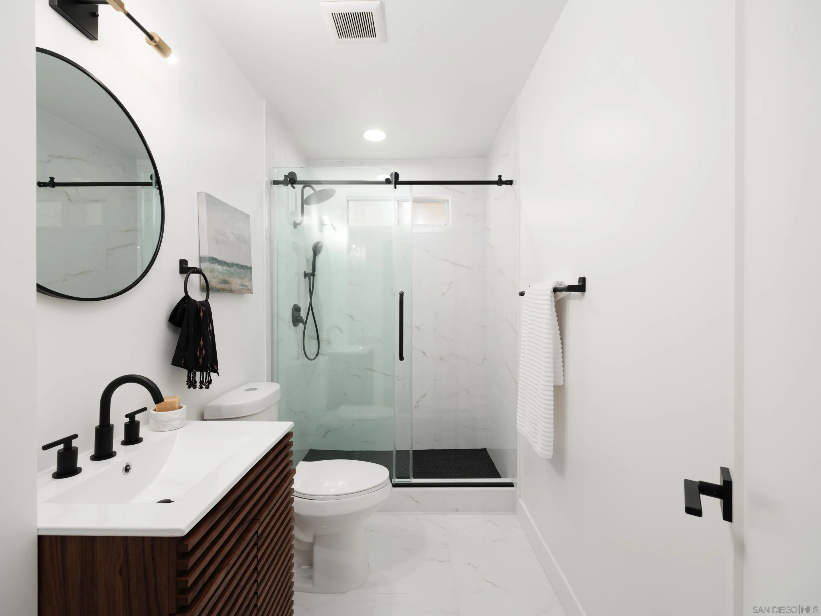 1868 Pariva Drive Cardiff, CA 92007 - Photo 28 of 30 a bathroom with a sink toilet and a mirror
