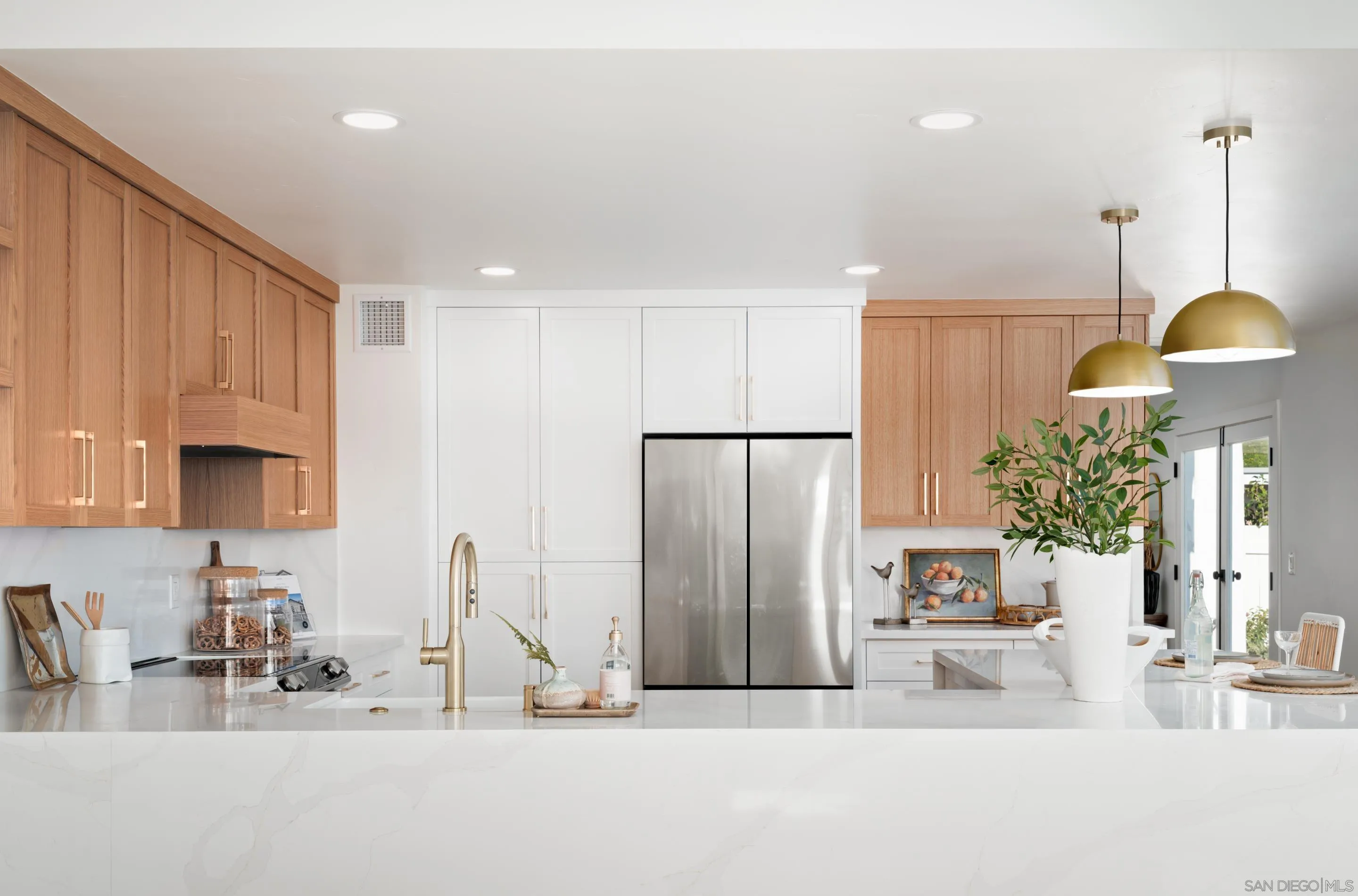 1868 Pariva Drive Cardiff, CA 92007 - Photo 7 of 30 a kitchen with stainless steel appliances granite countertop a refrigerator and a sink