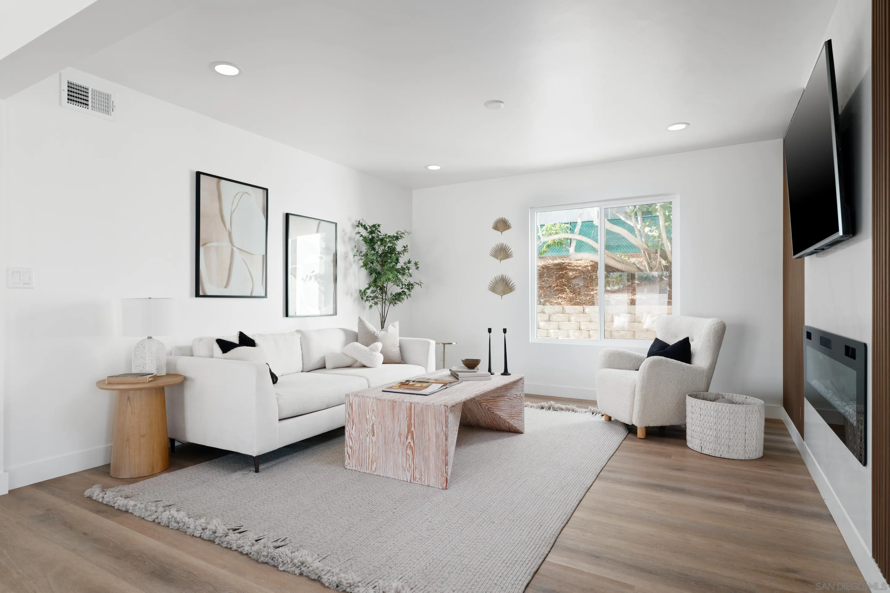 1868 Pariva Drive Cardiff, CA 92007 - Photo 8 of 30 a living room with furniture a fireplace and a flat screen tv