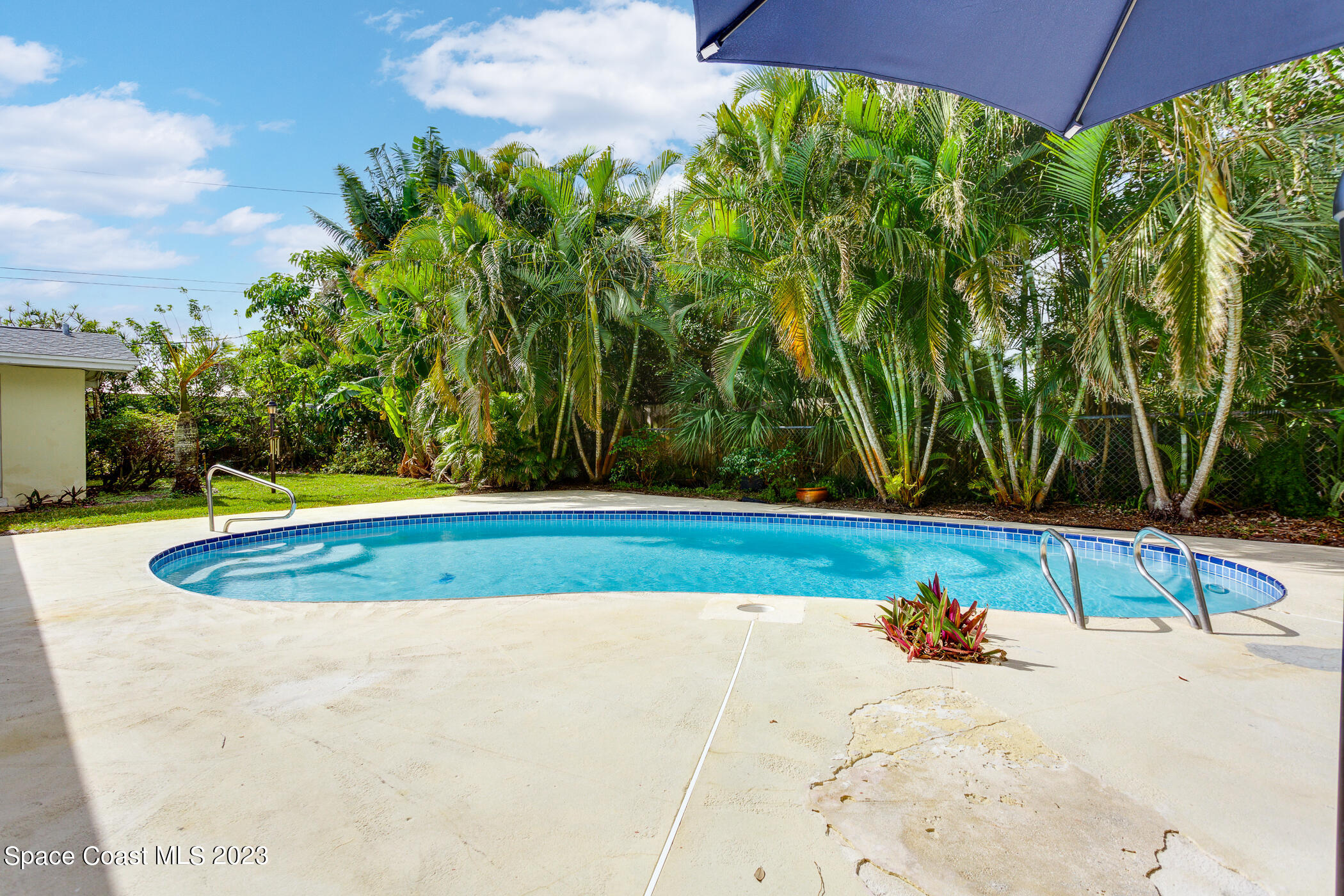 608 Mango Drive Melbourne Beach, FL 32951 - Photo 20 of 30 a view of a swimming pool with an outdoor space