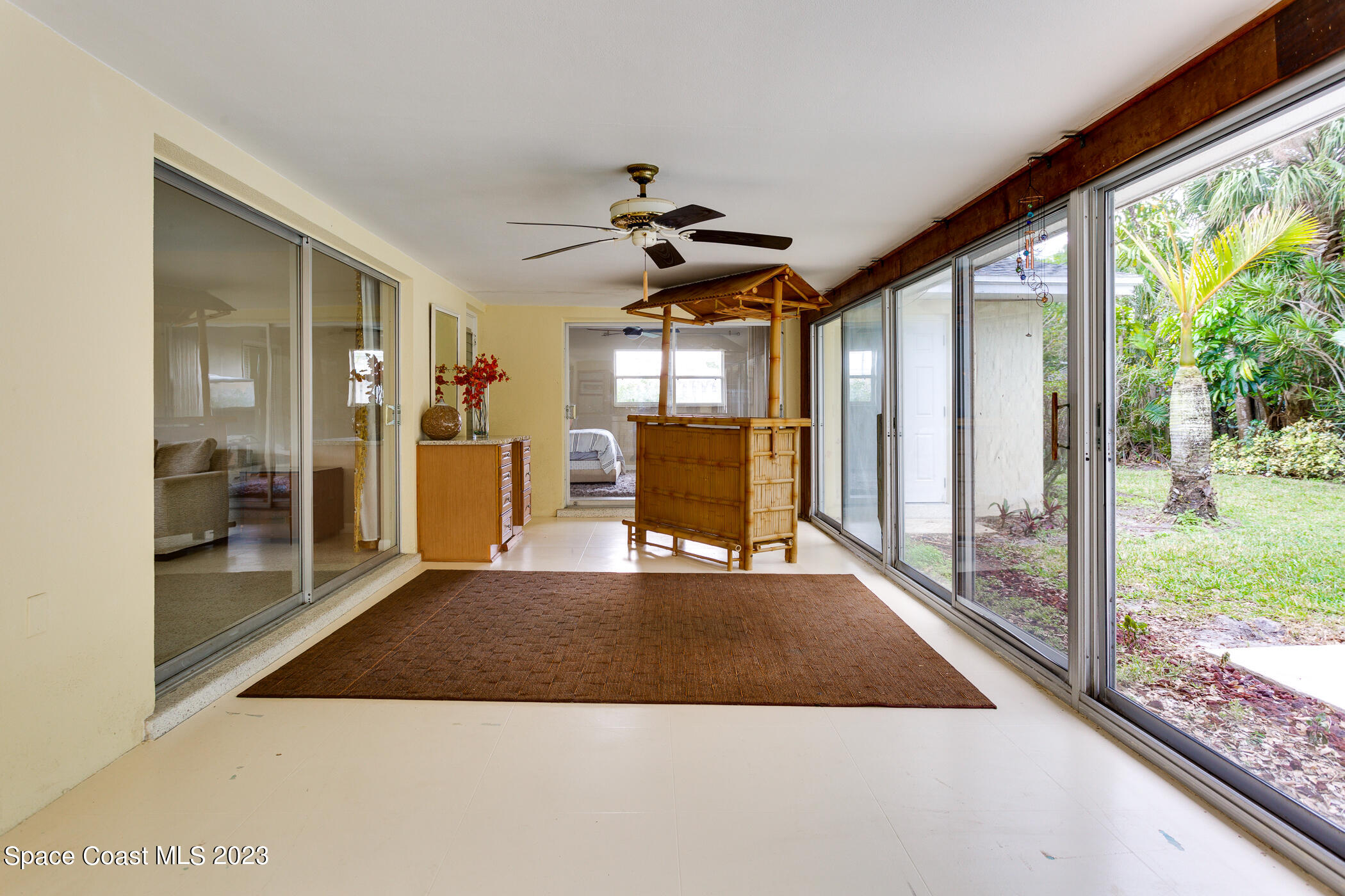 608 Mango Drive Melbourne Beach, FL 32951 - Photo 21 of 30 a view of a living room and a floor to ceiling window