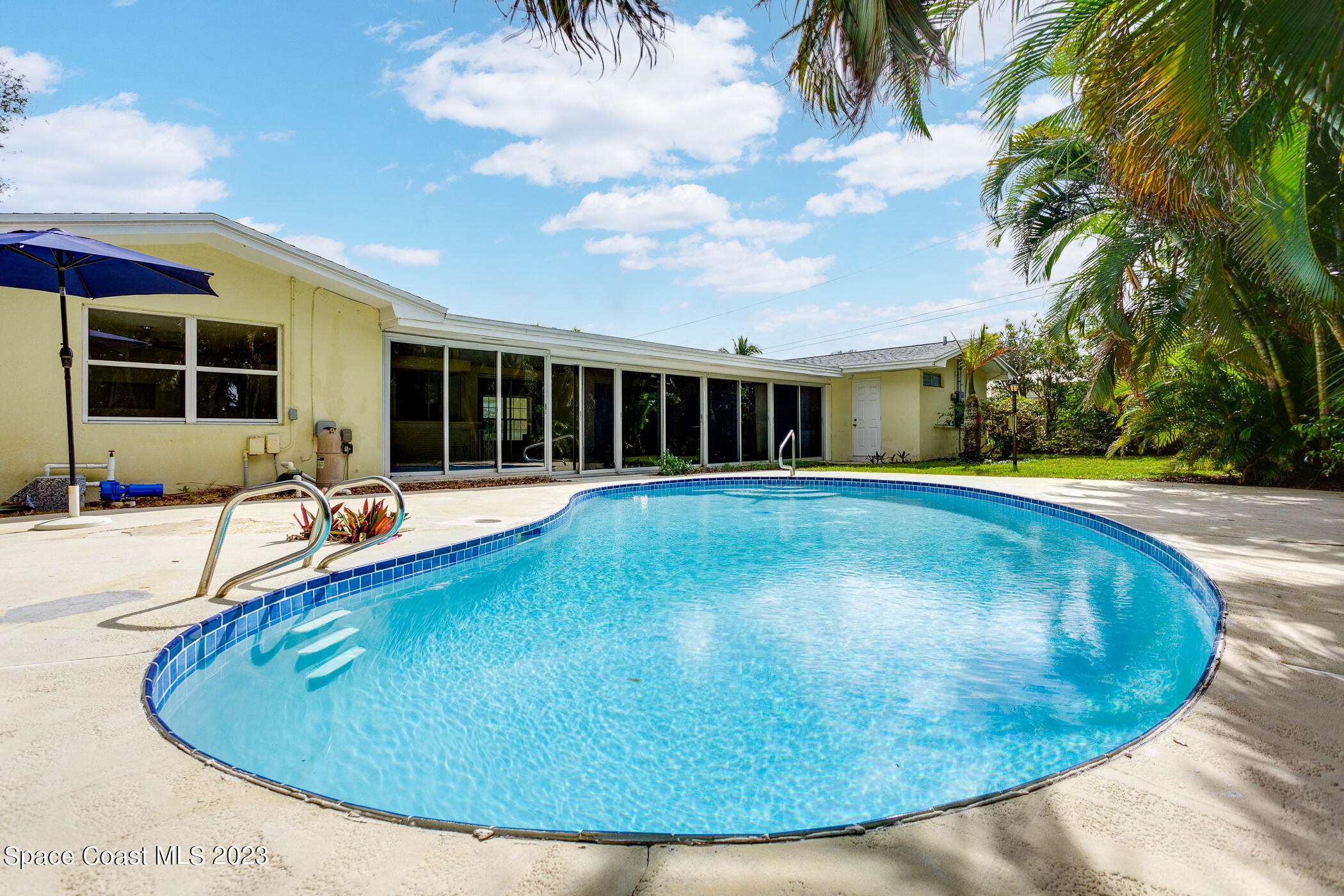 608 Mango Drive Melbourne Beach, FL 32951 - Photo 24 of 30 a view of a swimming pool with an outdoor seating