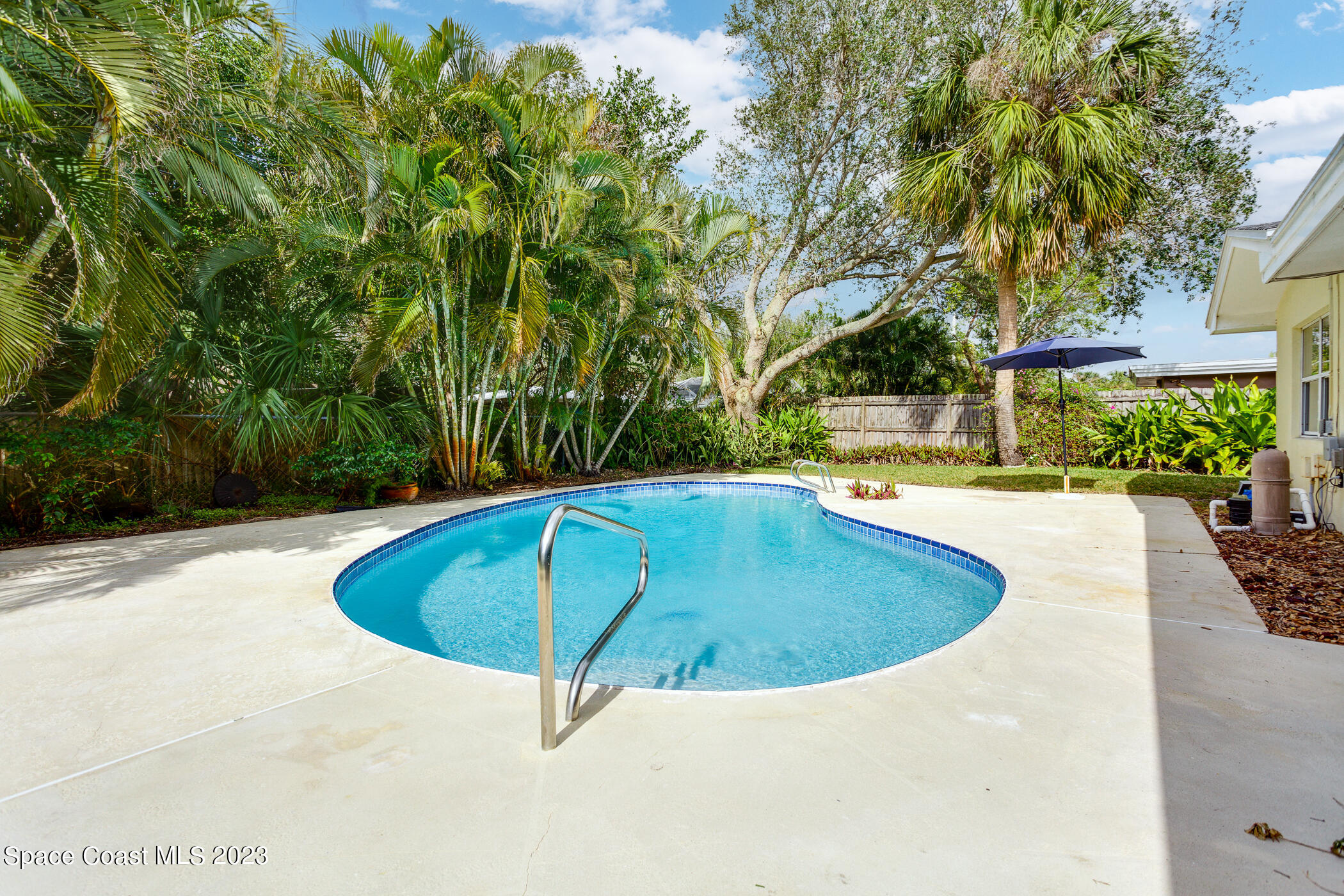 608 Mango Drive Melbourne Beach, FL 32951 - Photo 26 of 30 a view of a swimming pool with an outdoor seating