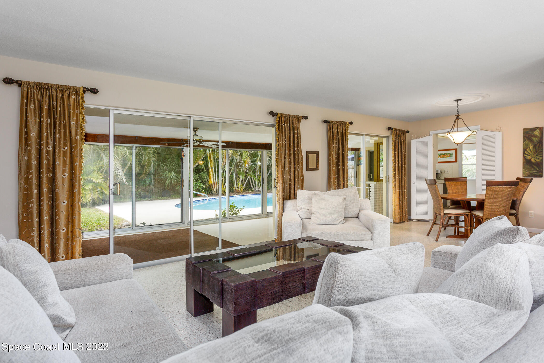 608 Mango Drive Melbourne Beach, FL 32951 - Photo 3 of 30 a living room with furniture and large windows