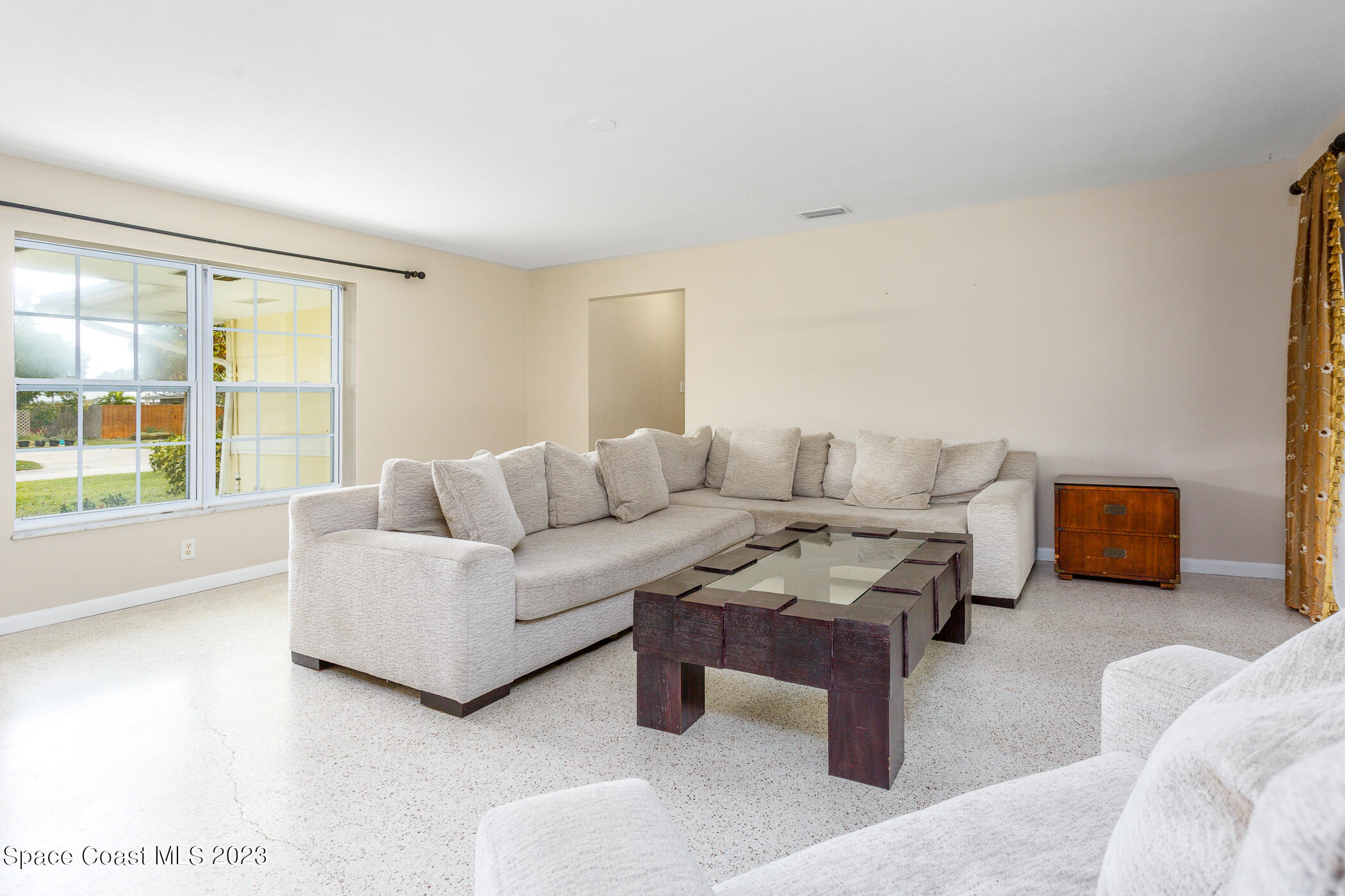 608 Mango Drive Melbourne Beach, FL 32951 - Photo 5 of 30 a living room with furniture and a large window