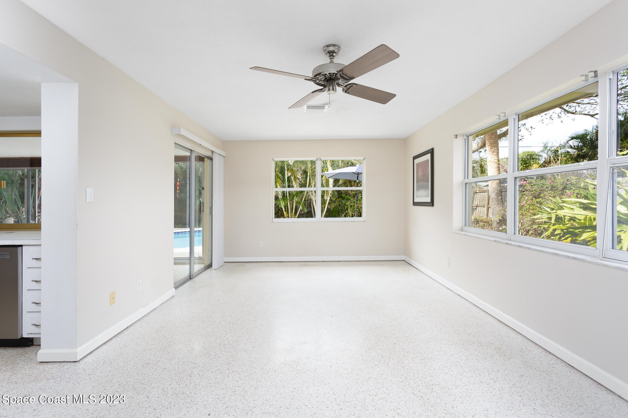 608 Mango Drive Melbourne Beach, FL 32951 - Photo 9 of 30 a view of a livingroom with a ceiling fan and window