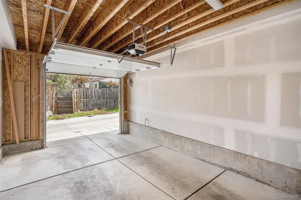 a view of a backyard with wooden fence and a stairs