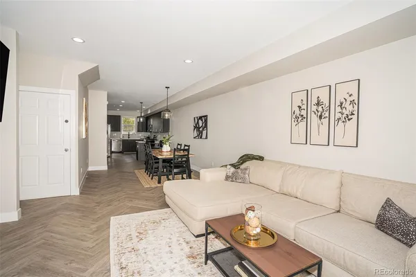 a living room with furniture and wooden floor