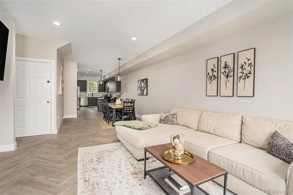 a living room with furniture and wooden floor