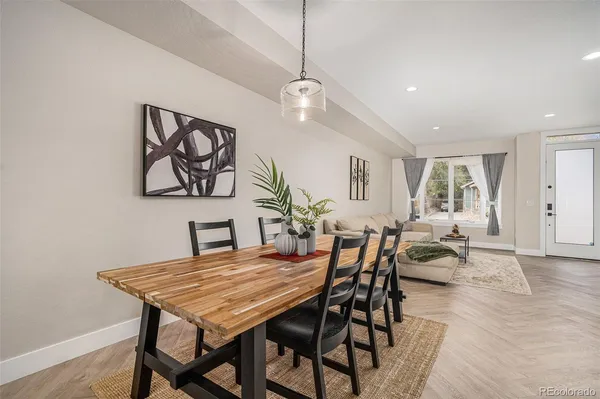 a dining room with furniture a rug and wooden floor