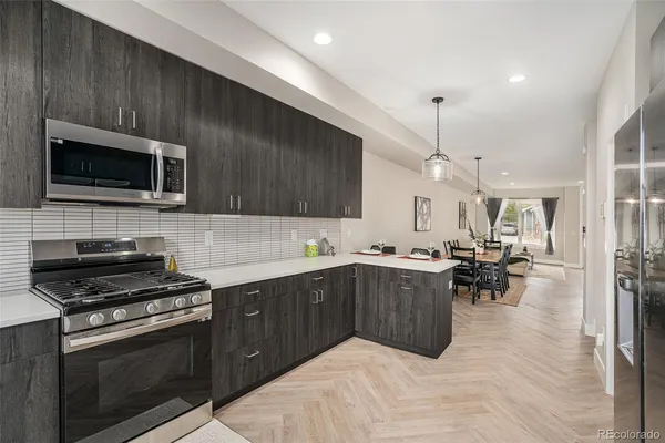 a kitchen with a sink stainless steel appliances and cabinets