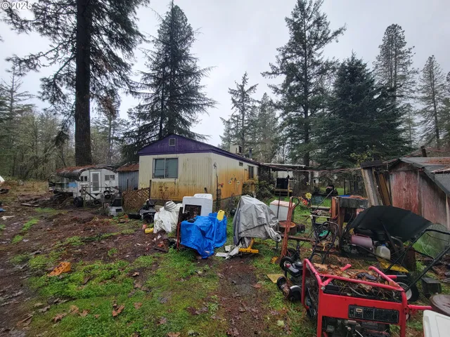 a view of a chairs and tables in the back yard of the house